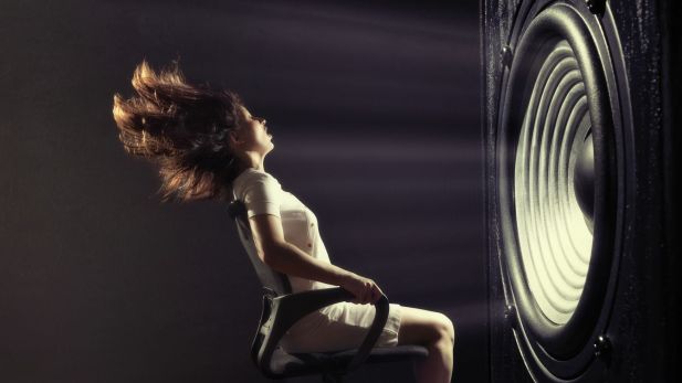 Woman in front of gigantic speaker